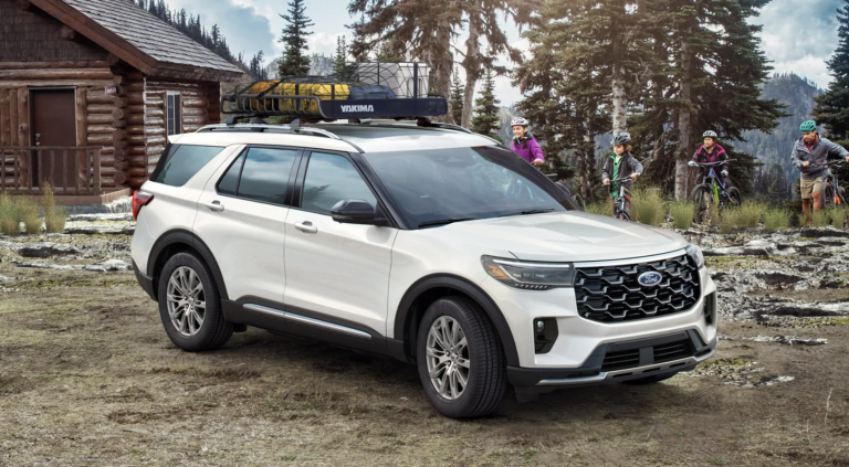 2025 ford explorer parked infant of cabin with family on bikes in background